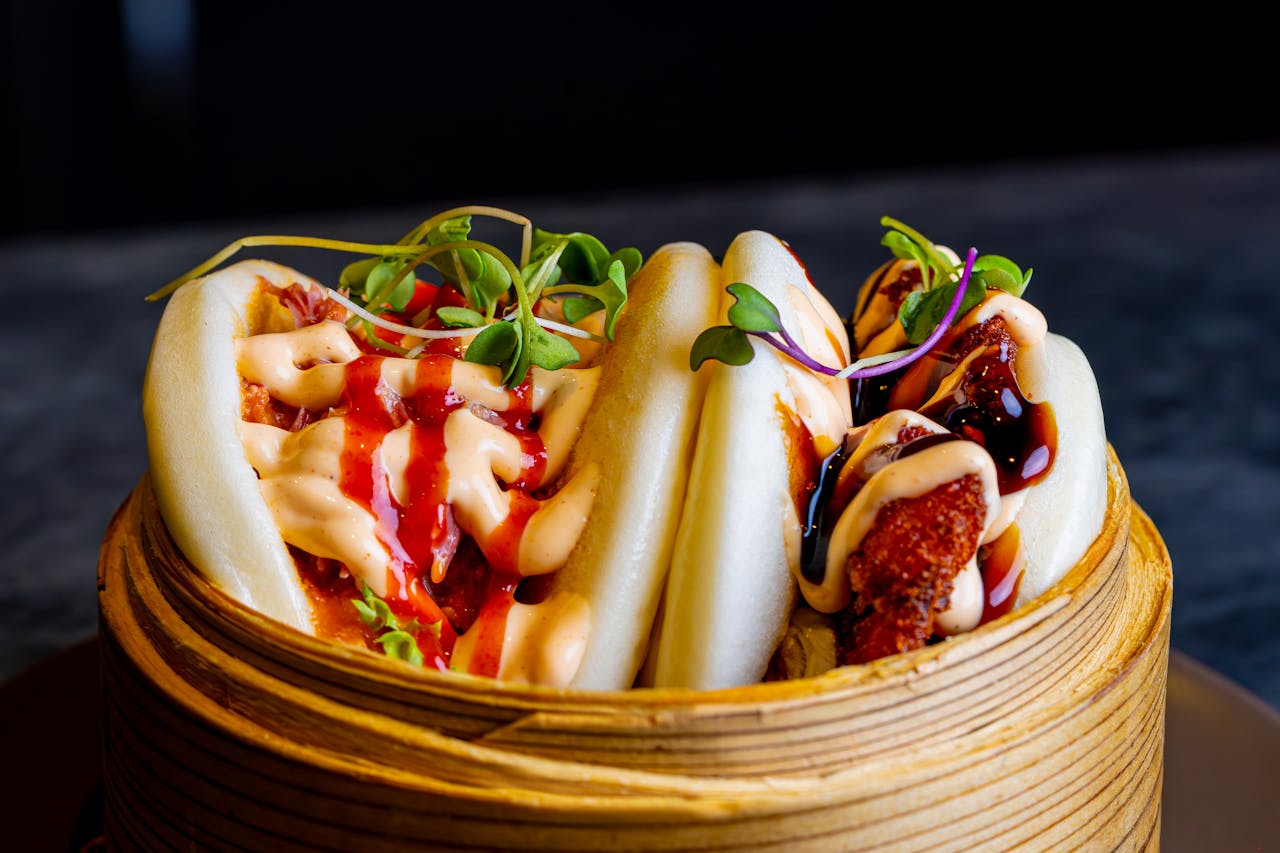 Gourmet bao buns with vibrant toppings in a bamboo steamer. Perfect fusion cuisine shot.